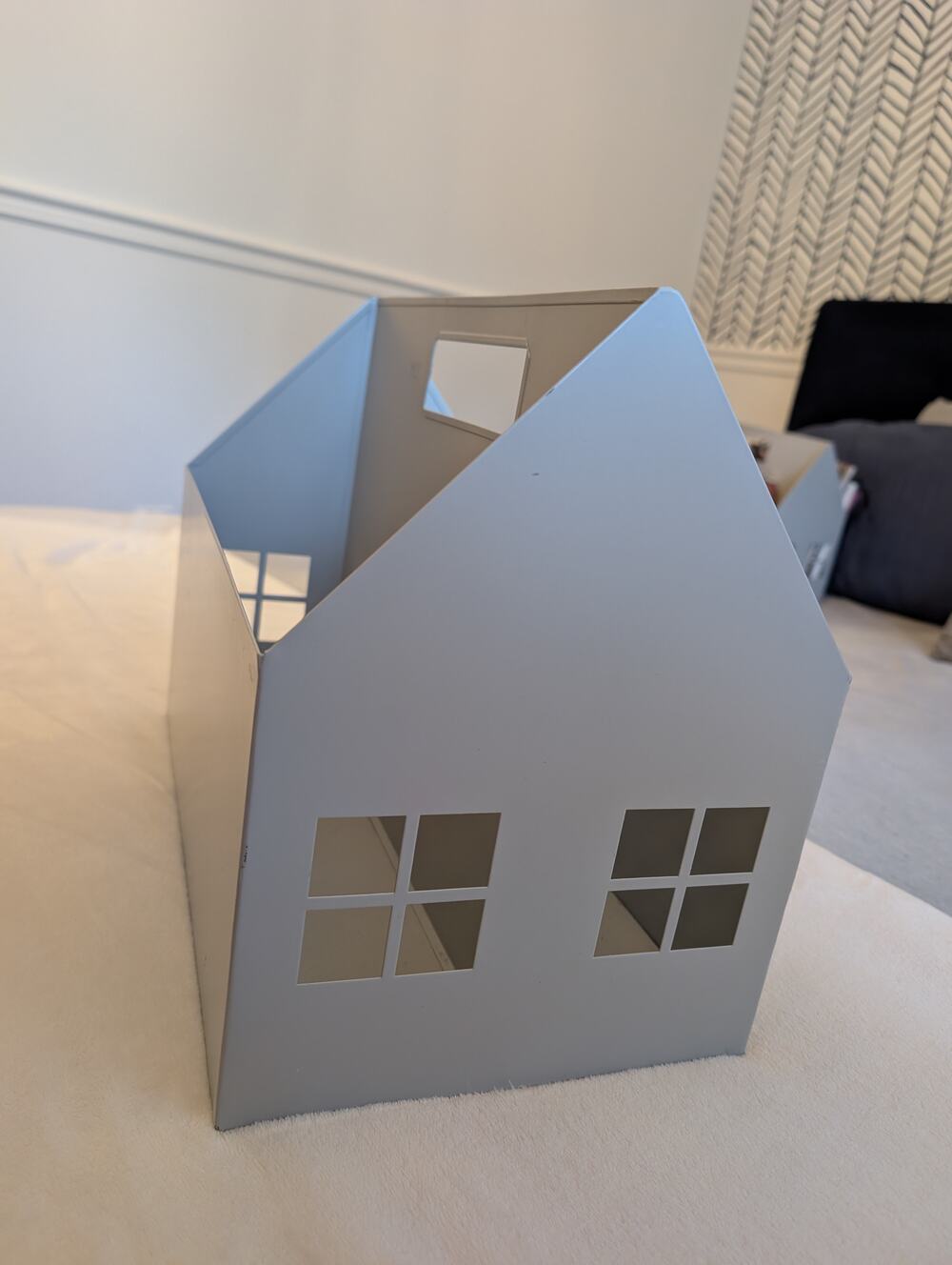 Metal house-shaped storage basket with window cutouts